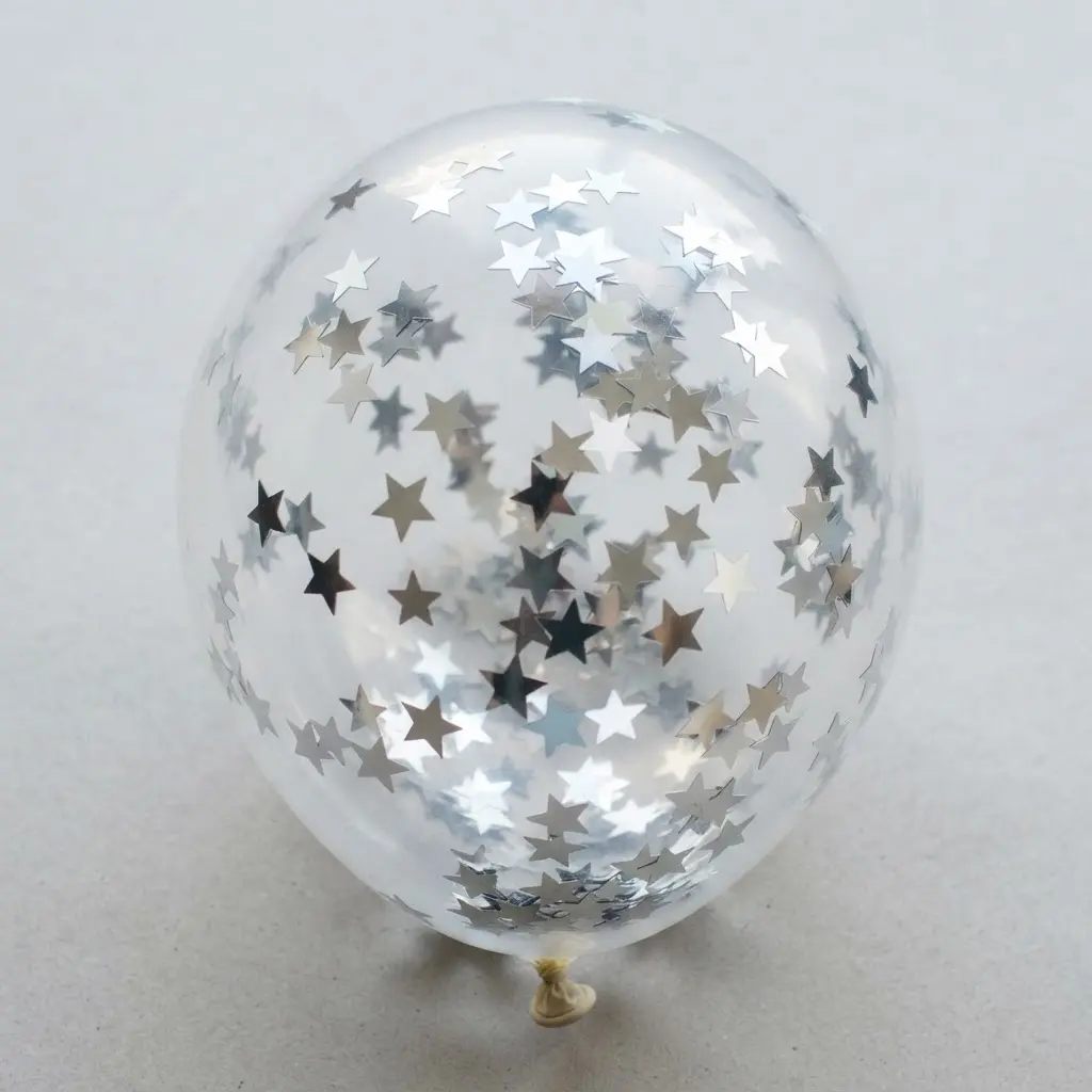 A party balloon showcasing tiny, reflective silver metallic star-shaped confetti dispersed throughout.