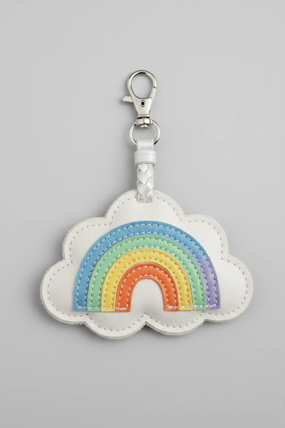 A light blue faux leather keychain cut into the detailed shape of a fluffy cloud with a smiling face.