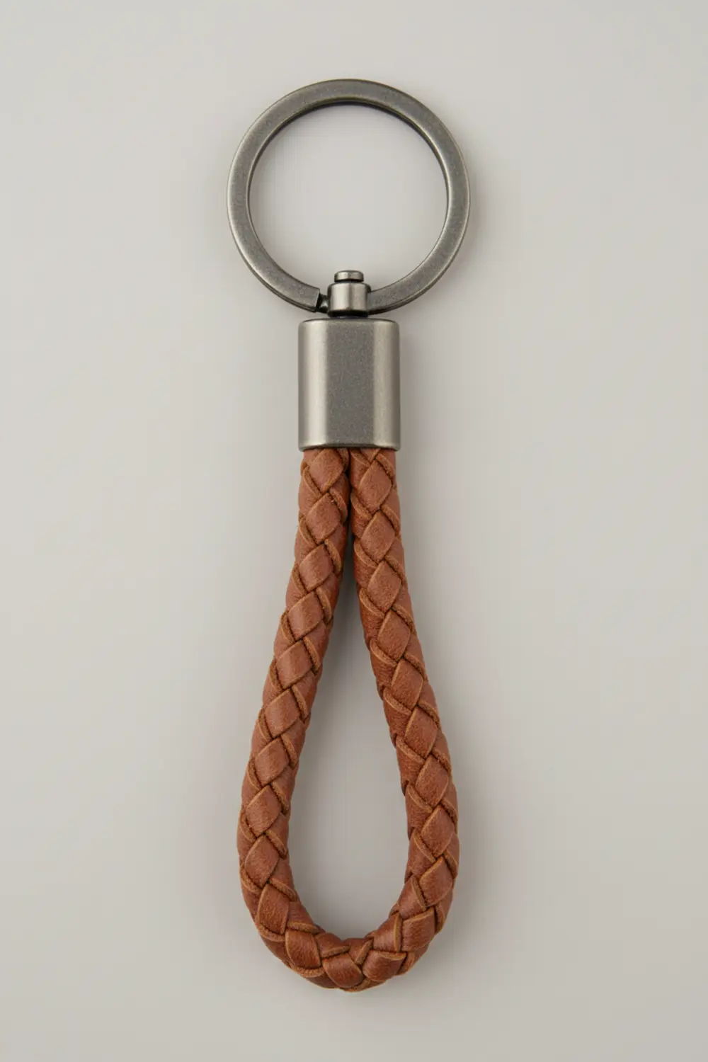 A sturdy keychain featuring a thick, three-strand braid made from burgundy faux leather cord.