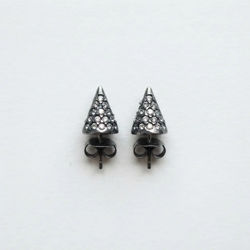Close-up view of spike stud earrings with tiny clear crystals embedded around the base of the spike.