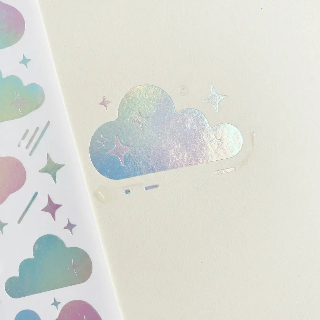 A sheet of colorful rub-on foil stickers with stars, clouds, and motivational words for a bullet journal.
