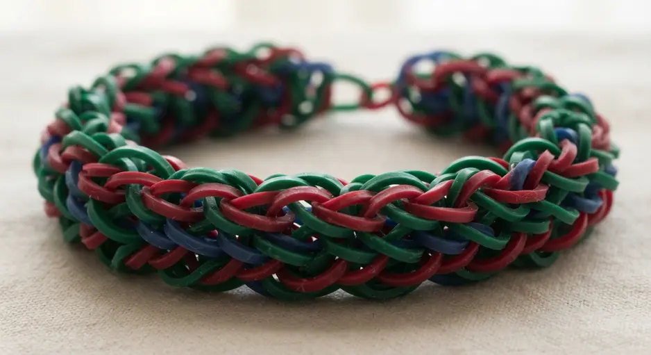 A wide, statement bracelet featuring a prominent, woven infinity symbol pattern.