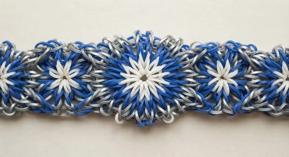 A loom bracelet featuring a geometric starburst design in the middle with radiating bands.