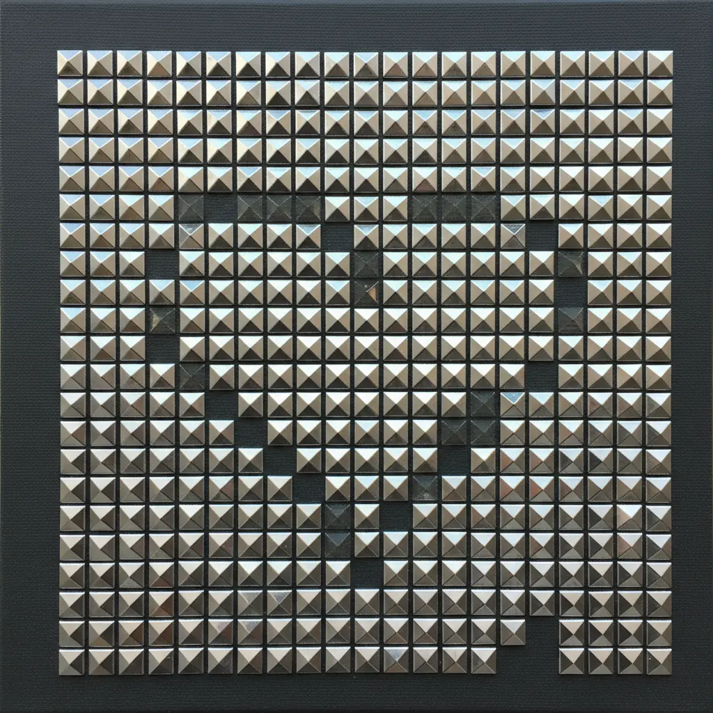 A heart shape completely filled with small silver pyramid studs, creating a textured mosaic on a charcoal canvas.