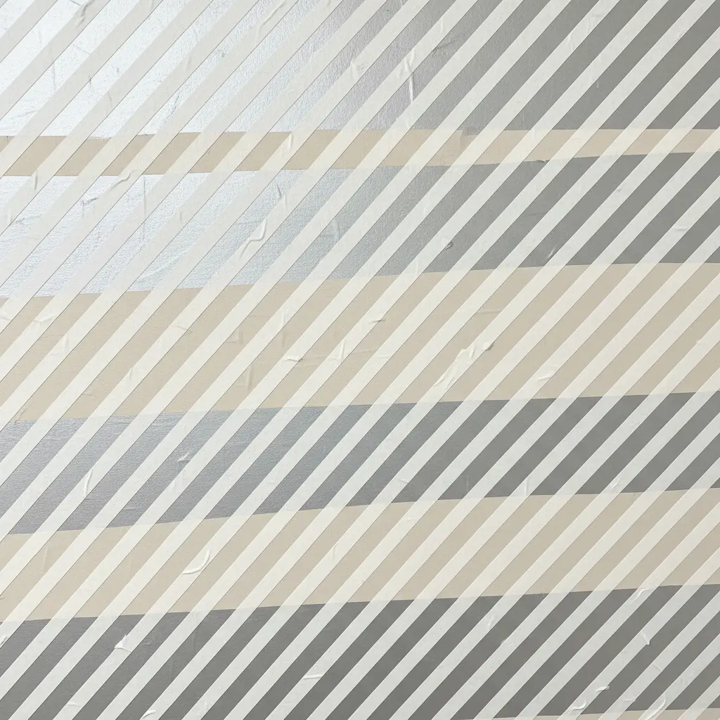 A wall with thick diagonal parallel stripes in white tape, adding energy and movement to the room.